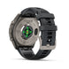 The back of a Fenix 9 Pro smartwatch with a dark gray silicone strap and a silver titanium case, showing the green heart rate sensor on a white background.