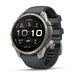 A Garmin Fenix smartwatch with a dark gray silicone strap and a silver-toned titanium case, shown at a three-quarter angle on a clean white background.