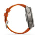 A side profile view of a rugged smartwatch with a metallic gray case and a vibrant orange silicone strap, shown on a clean white background.
