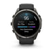 A Garmin smartwatch with a dark gray metallic case and a black strap, shown against a plain white background. The watch face is illuminated with a sleep tracking app screen.