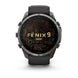 A Garmin Fenix 9 Pro smartwatch with a dark gray metallic case and a black strap, shown from the front on a white background. The watch face displays a black background with gold topographic lines and the text 'FENIX 9 PRO'.