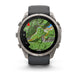 A rugged smartwatch with a round silver-tone metal case, dark gray strap, and a map display on the screen, shown on a clean white background.