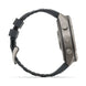 A side profile view of a rugged smartwatch with a dark gray textured strap and a metallic gray case, set against a plain white background.