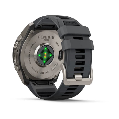 The back of a Fénix 9 Pro smartwatch with a dark gray silicone strap and a metallic gray titanium case, showing the heart rate sensor and green LED lights, on a white background.