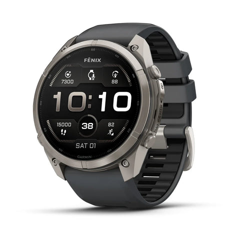 A Fenix smartwatch with a round silver titanium case and a dark gray silicone strap, shown at a three-quarter angle on a white background.