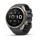 A Fenix smartwatch with a round silver titanium case and a dark gray silicone strap, shown at a three-quarter angle on a white background.