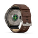A Fénix 9 Pro smartwatch shown from the back, featuring a brown leather strap, a brushed titanium case, and a green LED light indicator on a white background.