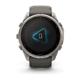 A Garmin smartwatch with a dark gray strap and a metallic silver-toned case, shown from the front on a clean white background.