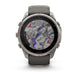A rugged Garmin smartwatch with a round silver-tone metal case and a dark gray silicone strap, shown on a clean white background. The watch face is active with a topographic map display.