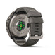 The back of a Fenix 9 G10 smartwatch with a dark gray silicone strap and metallic gray case, showing the heart rate sensor and green LED indicators, on a white background.