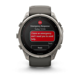 A Garmin smartwatch with a dark gray strap and silver-toned metal case, shown from the front on a white background. The watch screen displays an emergency response message with a red text box.