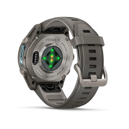 A rugged gray smartwatch shown from the back, featuring a textured gray strap, metallic gray case, and a central green and orange LED light display. The brand name 'FENIX 9' is visible on the back of the case.