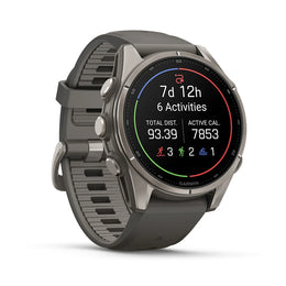 A Garmin smartwatch with a dark gray textured silicone strap and a silver-toned metallic case, shown at a three-quarter angle on a clean white background.