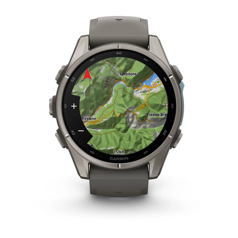 A Garmin smartwatch with a dark gray metallic case and matching dark gray silicone strap, shown on a clean white background. The watch face is active with a green topographic map display.