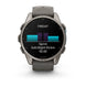 A Garmin smartwatch with a dark gray metallic case and a matching dark gray silicone strap, shown against a plain white background. The watch face is on and displaying a fitness screen with a running split and a bar chart.