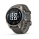 A Garmin smartwatch with a dark gray metallic case and a matching dark gray silicone strap, shown at a three-quarter angle on a white background.
