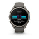 A Garmin smartwatch with a dark gray silicone strap and a metallic dark gray bezel, shown on a clean white background. The watch face displays a fitness screen with a cycling or running split graphic and the word 'FRIDAY'.