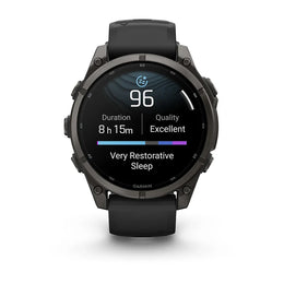 A Garmin smartwatch with a black round case and black strap, shown against a plain white background. The watch face displays a sleep and activity tracking interface.