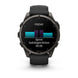 A Garmin smartwatch with a black strap and dark gray metallic case, shown from the front on a white background. The watch screen displays a fitness summary for 'FRIDAY' with a teal and purple bar graph and a sprint workout record.