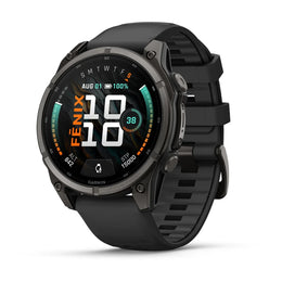 A Garmin smartwatch with a round black and dark gray case and a black textured strap, shown at a three-quarter angle on a white background. The watch face displays a digital fitness interface with the brand name 'GARMIN' visible at the bottom.