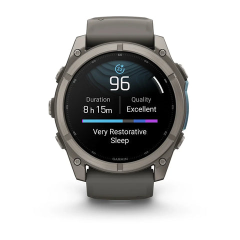 A Garmin smartwatch with a dark gray metallic case and matching dark gray strap, shown on a clean white background. The watch face displays sleep tracking information.