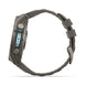 A rugged smartwatch shown from the side profile, featuring a dark gray textured silicone strap and a dark gray metallic case with a light blue accent on the side buttons.