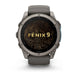 A Garmin Fenix 9 smartwatch with a dark gray titanium case and a dark gray strap, featuring a black screen with gold topographic lines and the text 'FENIX 9' in gold. The watch is centered on a clean white background.