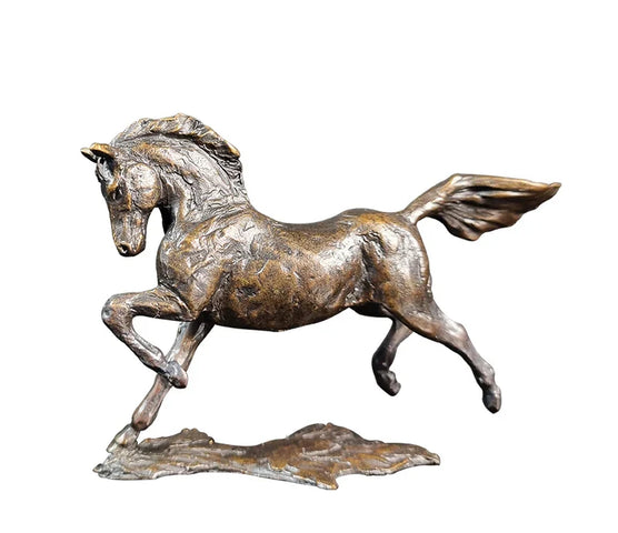 Bronze sculpture of a horse in mid-gallop on a white background