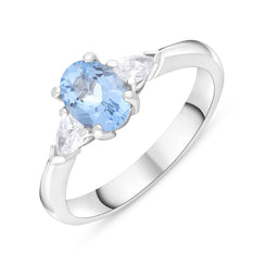 18ct white gold ring featuring an oval claw-set aquamarine weighing a total of 0.72 carats, complemented by two pear-shaped claw-set diamonds with a total weight of 0.22 carats. The design showcases a stunning combination of the blue aquamarine and sparkl