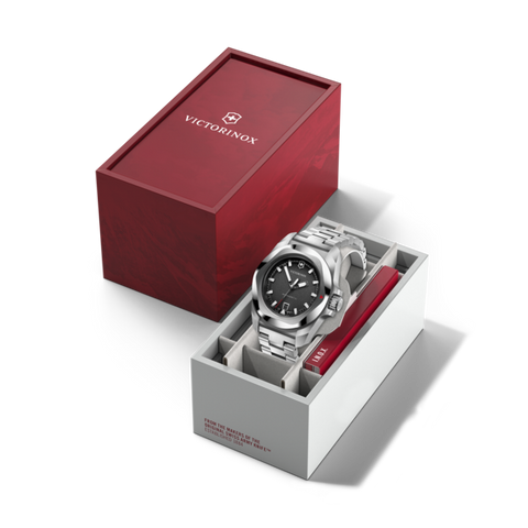 Silver watch in a white box with a red Victorinox box on a white background
