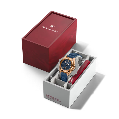 Victorinox watch with blue strap and rose gold case in a white box on a white background