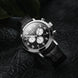 Black wristwatch with a detailed face on a dark textured background