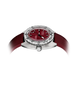 A wristwatch with a silver-toned case, a deep red dial, and a matching red textured strap, shown on a plain white background.