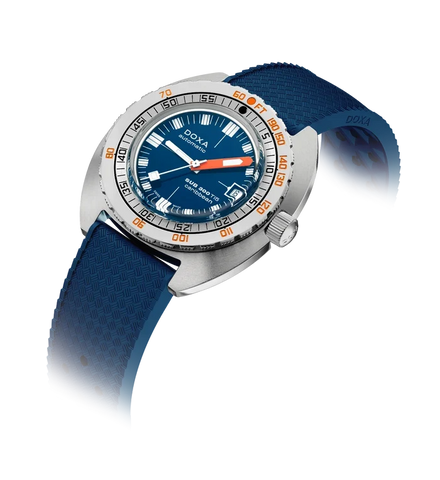 A Doxa wristwatch with a blue dial, blue textured strap, silver-toned stainless steel case, and orange accents on the bezel and hands, shown on a white background with a soft shadow.