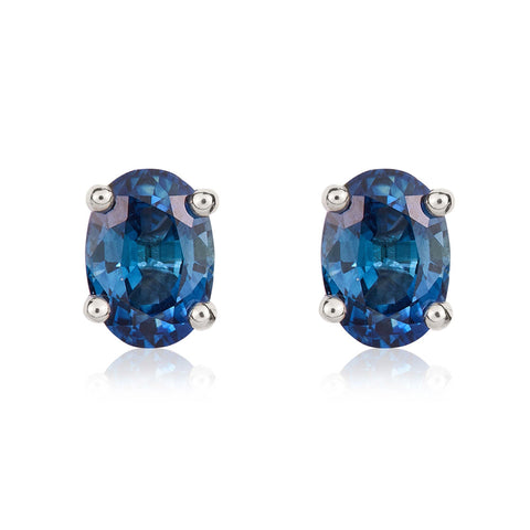 9ct White Gold Sapphire 7x5mm Oval Claw Set Stud Earrings. 33-21-065.