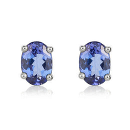 9ct White Gold Tanzanite 7x5mm Oval Claw Set Stud Earrings. 33-24-089.