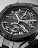 Maurice Lacroix watch with detailed mechanical components on a gray background