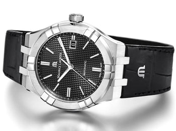 Luxury watch with black dial and leather strap on a white background
