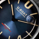 Close-up of a U-Boat watch face with blue background and gold accents