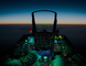 Pilot's view from inside a fighter jet cockpit during night flight.