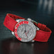 A wristwatch with a silver-toned dial, a red and silver rotating bezel, and a bright red textured strap, photographed on a dark reflective surface.