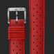 A close-up of a red textured watch strap with a silver-toned buckle, shown alongside a vertical detail view of the perforated strap pattern on a dark gray background.