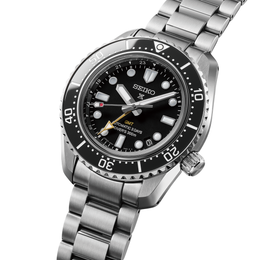 Seiko watch with black dial and silver metal bracelet on a white background