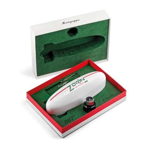 A Montgolfi 007 Zorin personal air rifle presented in an open red and white gift box with a green interior, alongside its open presentation box showing the molded compartment.