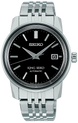 Seiko watch with black dial and silver metal bracelet on a white background