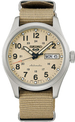 Seiko watch with beige face and brown strap on a white background