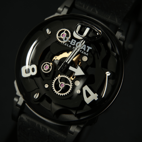 Close-up of a black watch with visible mechanical components on a dark background