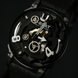 Close-up of a black watch with visible mechanical components on a dark background