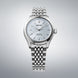 Silver Seiko watch on a gray background