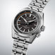 Seiko watch with silver metal bracelet on a light gray background